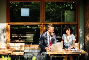 man and woman discussing website content outside coffee shop